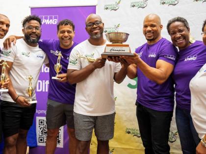 From left: Leigh Dwyer, Daren Latchman (reserve), Jerazeno Bell, and Mario O’Connor of the Saints accept the KPMG Squash League trophy from Al Johnson (third right), audit partner at KPMG, while Karen Anderson (second right), Jamaica Squash president, an