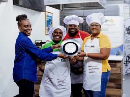 Takese Foga (left), director, health promotion & education, Ministry of Health & Wellness, presents the top award to Salina Campbell, Rasheed Whyte and Chaudine Parker of the Sugar Industry Authority, winners of the Healthy Recipe Cook-Off Challenge. The c