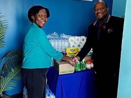 Jennifer Gordon, Laparkan Shipping’s administrative and maintenance manager, hands over essential items to Fabian White, a representative from the Ministry of Finance and Civil Service Group. Mr. White spearheaded the outreach to the private sector for d