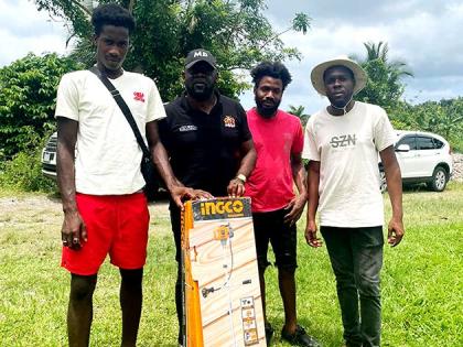 Member of Parliament for South‑East St Mary, Christopher Brown (second from left), with beneficiaries after presenting a weed whacker under the A‑Start Initiative on Wednesday.