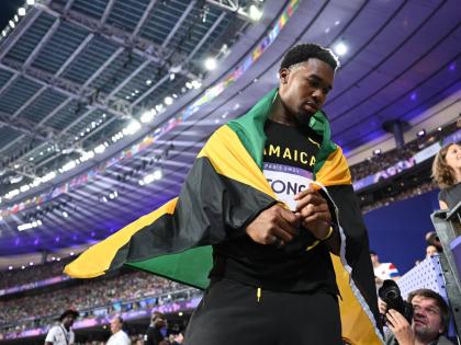 Jamaica's Roje Stona celebrates an Olympic record-breaking gold-medal performance in the men’s discus at the Stade de France in Paris, France, on Wednesday, August 7.