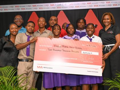 Foga Road High School collects their symbolic cheque from Samantha Charles (right), CEO of the VM Foundation, at the end of the pitch competition. At left (back) is Andre Robb, programme lead, VM Foundation. 