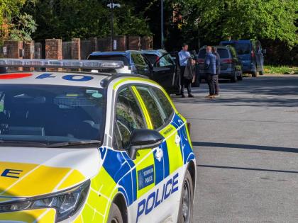 Police officers patrol at a cordon near Kenton United Synagogue in Harrow, a suburb of London.