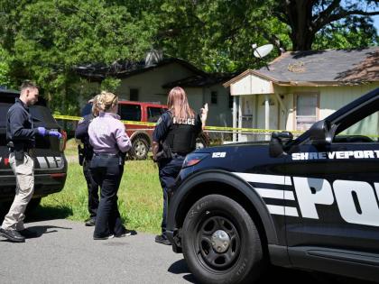 Police gather in front of a house on Harrison Street near Bernstein Avenue, in Shreveport, La., as they investigate a mass shooting, Sunday, April 19, 2026. (Jill Pickett/The Times-Picayune/The New Orleans Advocate via AP)
