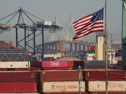FILE - Containers with Yang Ming Marine Transport Corporation, a Taiwanese container shipping company, are stacked up at the Port of Los Angeles with the the Long Beach International Gateway Bridge seen in the background on Wednesday, April 9, 2025 in Los 
