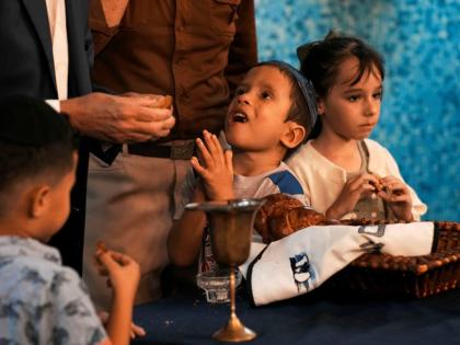 Jewish children eat pieces of Callahan bread after the prayer was recited during a Shabbat service at the Beth Shalom synagogue, in Havana, Cuba.