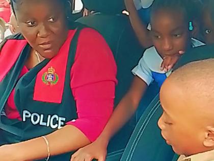 Green Acres Police Station Manager Sergeant Clarine Brooks demonstrates the features of a police vehicle to students of St John’s Primary during a recent road‑safety and transportation session.