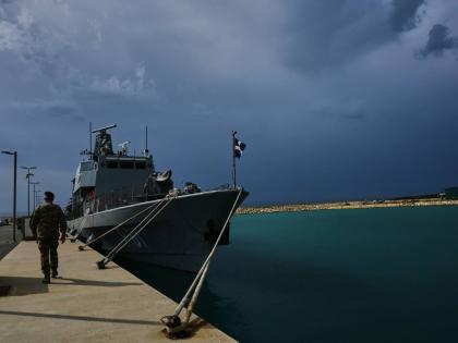 A Cyprus’ military officer walks by a frigate at the Evangelos Florakis naval base in Mari, Cyprus, on April 17.