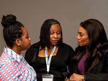 Mesheka Brown (centre), Grant a Wish beneficiary, shares some of the details of her experience with aunt Shereka South (left) and Belinda Williams, interim head of the Group Sales Marketing Unit at NCB.