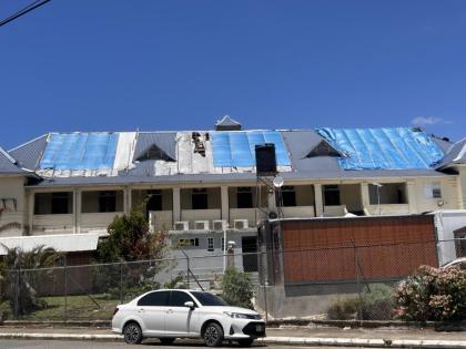 Visible damage to the court building, with deteriorating tarpaulins and unsafe conditions forcing the staff out.