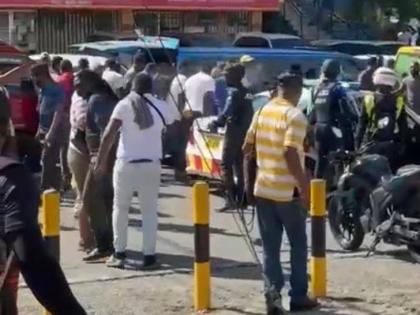 A police team among a crowd on Chancery Avenue in St Andrew on April 21, 2026.