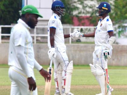 
Barbados Pride batsmen Kevin Wickham (centre) and Kraigg Brathwaite meet mid-pitch during their century stand against the Jamaica Scorpions on day three of their West Indies Championship match at Sabina Park last week.