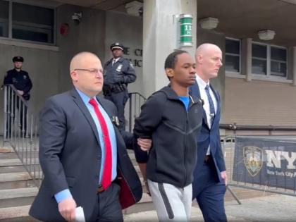 Zahir Davis, 18, getting walked out of the 113th Precinct in Queens, New York, on Saturday.