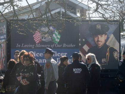 New York Police Department Officer Jonathan Diller is on a screen during his funeral service at Saint Rose of Lima R.C. Church in Massapequa Park, N.Y., March 30, 2024. (AP Photo/Jeenah Moon, File)