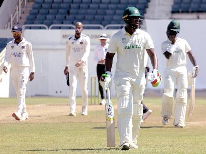 Jamaica Scorpions batsman Javelle Glenn (second right) walks off the field on day two of the West Indies Championship cricket match against the Barbados Pride at Sabina Park, in Kingston yesterday.