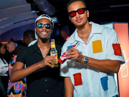 Content creators Walter Grant Jr (left) and Adam Bogle share a toast in honour of the night’s celebrations.