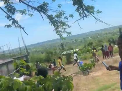 Residents of Mountainside in St Elizabeth converge at the home where the fatal stabbing occurred on Tuesday.