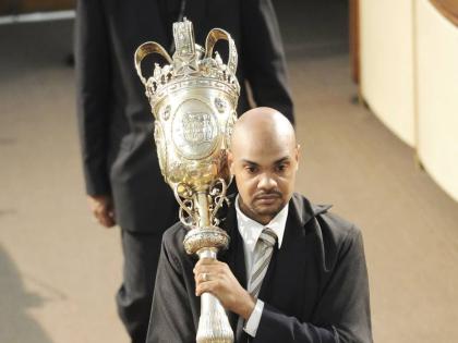 The then new House marshal, Kevin Williams, carries the mace during the opening of the new session of Parliament in 2012. The current House marshal is Captain Wayne Blake. 