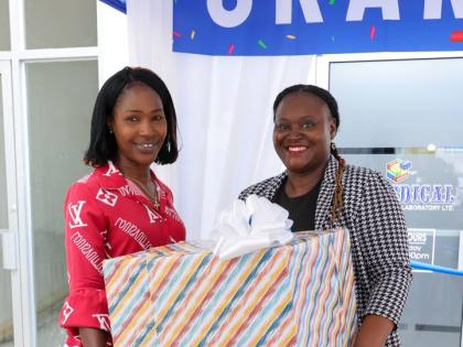 Tamar Donaldson-Watson (left), senior teacher at the Jonathan Grant High School in St. Catherine accepts Caledonia Medical Laboratory (Biomedical’s) Impact Recognition presentation on behalf of the school’s Home Economics Department and teacher, Sanjae