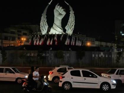 Vehicles drive past a monument depicting the clenched fist of the late Iranian Supreme Leader Ayatollah Ali Khamenei, who was killed in the US and Israel strike on February 28.