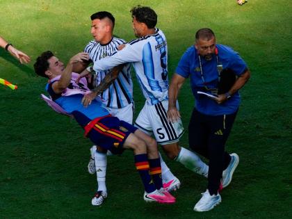 Spain’s Gavi (left) falls as he scuffles with Argentina’s Leandro Paredes (5) and Thiago Almada after the World Cup final between Spain and Argentina in East Rutherford, New Jersey on Sunday, July 19, 2026.  