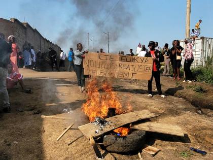 Rubble set on fire as health and frontline workers protest at the Elikya Ebola Treatment Center in Bunia, Congo, on Saturday, July 25, 2026. (AP Photo/Constant Same Bagalwa)