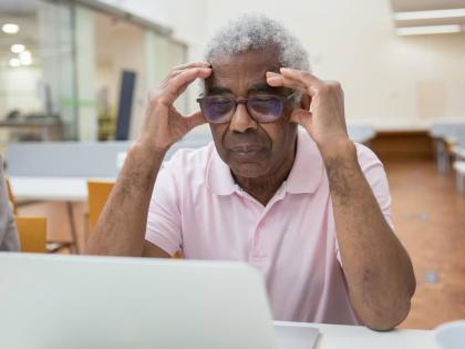 Representational image of a senior citizen having difficulties with technology.