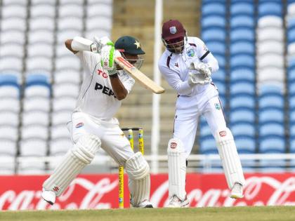 Pakistan batsman Shan Masood plays square of the wicket while West Indies wicketkeeper Shai Hope looks on during action from day two of their Test match at the Brian Lara Cricket Academy in Tarouba, Trinidad yesterday.