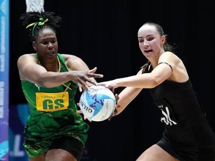 Sunshine Girls goal shooter Romelda Aiken (left) and goalkeeper Kelly Jackson compete for the ball during their Commonwealth Games Pool B netball game inside the Hydro yesterday.