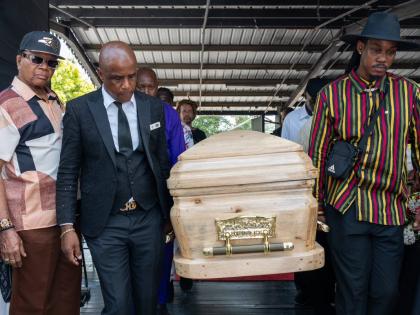 Funeral director Peter Perry (second left) and Rasheem Cole, Stranger Cole’s grandson, lead the pallbearers as entertainment industry insider Copeland Forbes looks on.