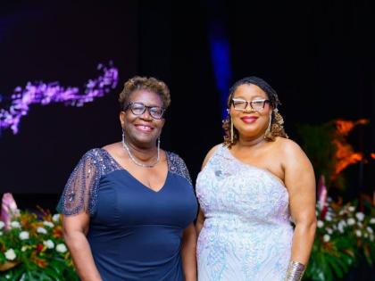 Former Director of Public Prosecutions Paula Vanessa Llewellyn (left) pauses for a photo with Miss Anieta Bailey, community relations education officer for Region 5 of the Ministry of Education, Skills, Youth and Information.