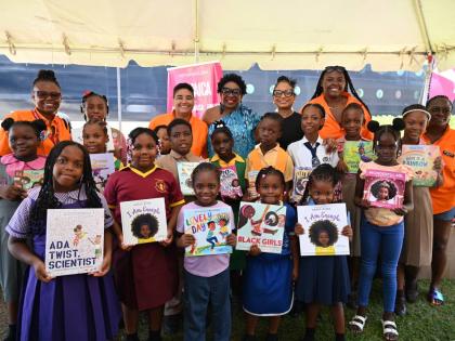 Sarah’s Children Chairman Janet Silvera and Odette Dyer, regional director of the Jamaica Tourist Board, share lens time with Festival at Sea representatives and students from.schools across western Jamaica during the donation of books at Historic Falmou