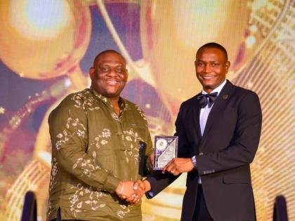 Senator Marlon Morgan (left), parliamentary secretary in the Ministry of Education, Skills, Youth and Information, presents the Outstanding Leadership in Education Award to Dr Mark Smith, principal of Munro College and immediate past president of the Jamai