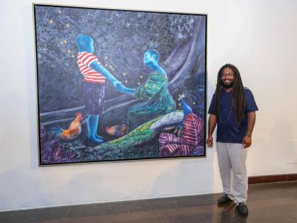 
Visual Artist, Richard Nattoo next to his creation, The Majician’s Arrival. 