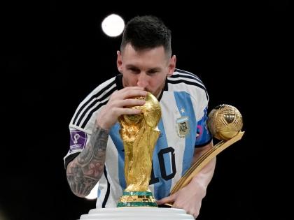 Argentina’s Lionel Messi kisses the trophy after winning the World Cup final match against France in Lusail, Qatar on December 18, 2022. Argentina won 4-2 in a penalty shootout after the match ended tied 3-3. 