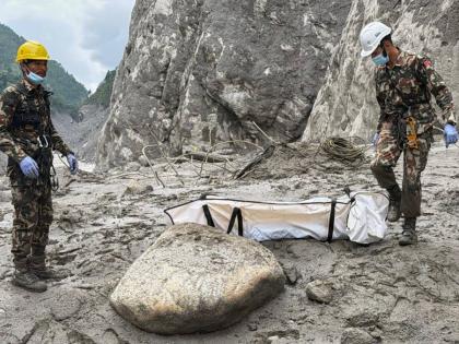 Nepal Army soldiers carry a body of a worker recovered from the site of a hydropower project in Upper Trishuli, Nepal, on Tuesday. - AP photo