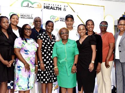Minister of Health and Wellness, Dr Christopher Tufton (fifth right), along with officials from the ministry, pose with health researchers, during a ceremony for the handover of cheques to five researchers under the Ministry of Health and Wellness’ Resea