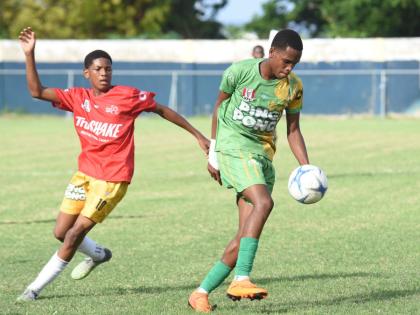 Ocho Rios High’s Dario James (right)  tries to get a ball under control while being hounded by Old Harbour High’s  Dimell White during their opening match of the ISSA Ben Francis Cup KO at Drax Hall Sports Complex last season.
