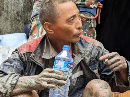 In this photo provided by the Nepal Army, a Chinese national is seen drinking water after being rescued by soldiers during an ongoing operation at the Trishuli-3A hydropower project in Nepal's Rasuwa district, Saturday, Sept. 5, 2026. (Nepal Army via AP)