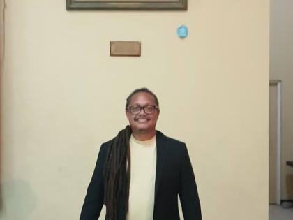 Rev’d Ignacio Barrera Kelly of San Andres, Colombia, stands beneath a portrait of George Liele on the compound of the East Queen Street Baptist Church. Liele, a Black American, is credited with founding the Native Baptist movement in Jamaica.