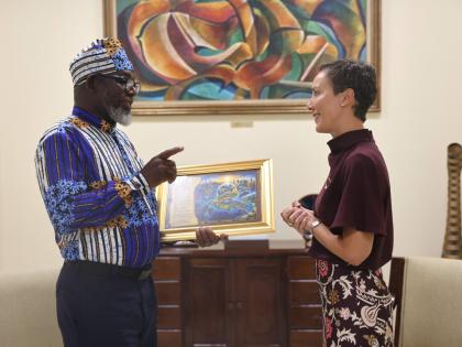 
Garfield Angus, senior Journalist at the Jamaica Information Service, speaks with Senator Kamina Johnson Smith, minister of foreign affairs and foreign trade, during the presentation of his narrative poem, ‘Out Of Many, One Global Family: The Diaspora R