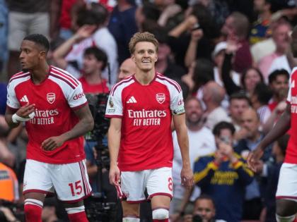 Arsenal’s Martin Odegaard (centre) reacts after scoring the winner during the English Premier League match between Arsenal and Chelsea in London yesterday.