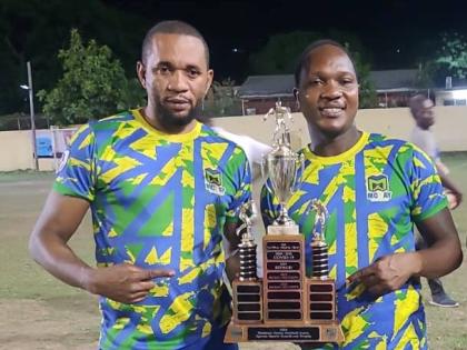 McKay Security’s Rohan Williams (left) and Akeem Higgins pose with the Kingston and St Andrew Business House Football Association Knockout Trophy after defeating Seprod 2-0 at Constant Spring on Saturday.