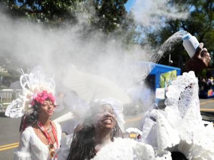 Members of the Belmont Baby Dolls throw baby powder as they wait for the start of the West Indian American Day Parade in the Brooklyn borough of New York on Monday. - AP photo