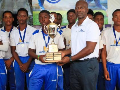 CEO Mark Williams presents the winners’ trophy to Middlesex in the 2026 Kingston Wharves Under-15 Competition, after that county defeated Surrey at the JDF field.