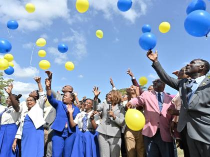 Senator Dana Morris Dixon, (centre)  Minister of Education; Carlon Pitt, (second right) Principal of the School; Dr. Walton Small, (right) Retired Principal of Hydel High and Icylin Golding, (second left) Custos Rotolorum of St. Catherine and students rele