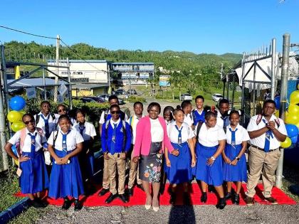Principal Beverley Feare shares a moment with students on Monday after welcoming them on the red carpet for Maud McLeod High School’s first day of single-shift schooling since 2008.