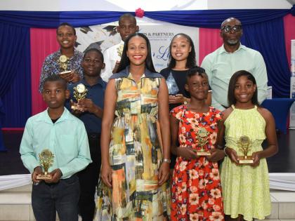 The JPS & Partners Co-operative Credit Union’s 2026 scholarship recipients share a proud moment with keynote speaker Rhoda Moy Crawford (front row, second left), member of parliament, and minister of state in the Ministry of Education, Youth, Skills and 