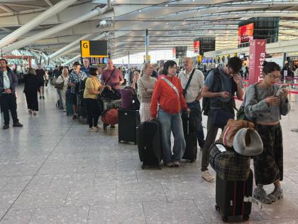 Passengers wait in line at Heathrow Airport in London, during an air traffic control problem that disrupted travel across Britain. (Jonathan Brady/PA via AP)