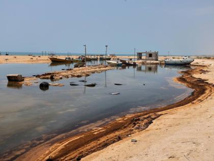 Oil residue lines the shore near fishing boats on Qeshm Island, Iran, amid ongoing wartime attacks on vessels and infrastructure in and around the Strait of Hormuz, though the spill's source has not been independently determined. - AP photo